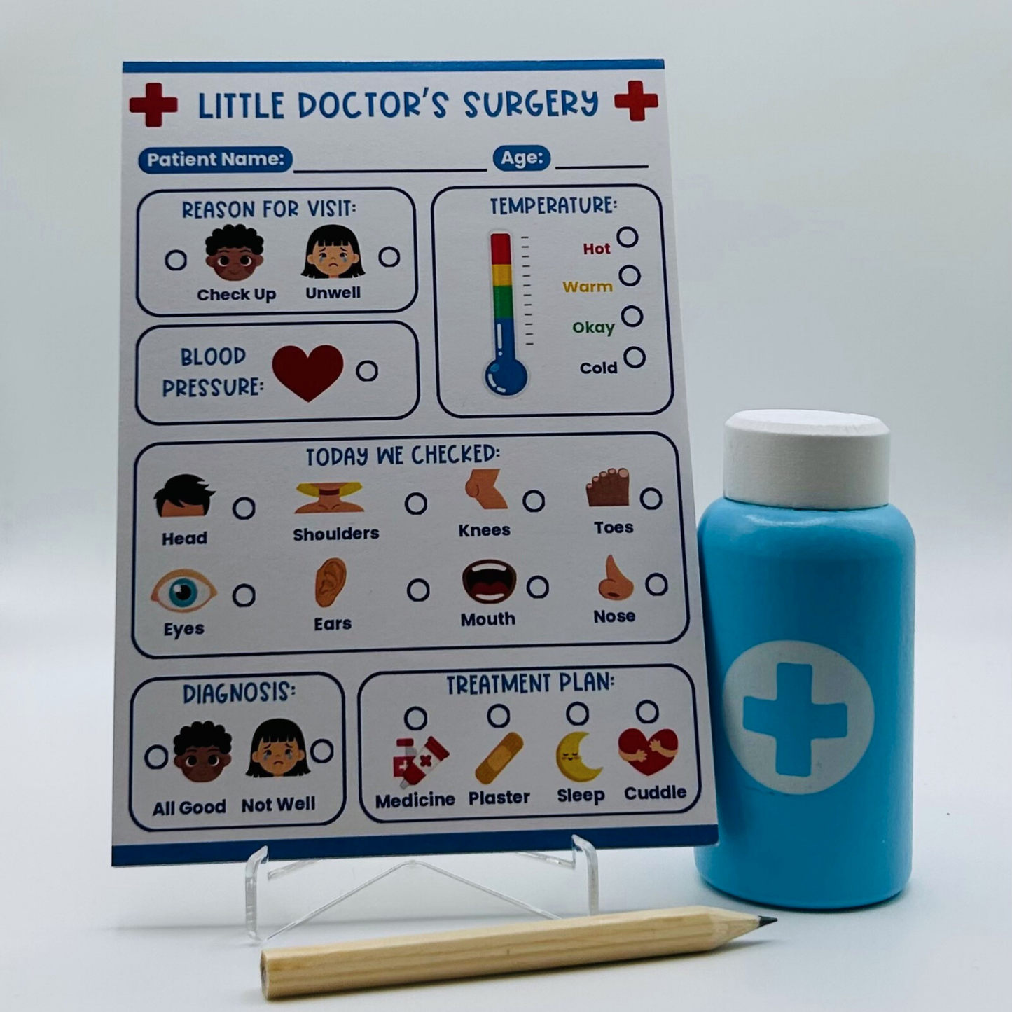 Children's play set with 'Little Doctor's Surgery' pretend play notepad, blue bottle, and pencil on a white background