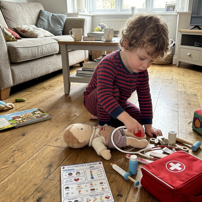 Little Boy playing doctor role play with pretend play notepad
