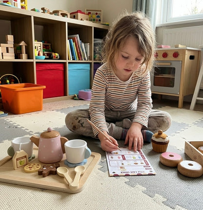 child playing pretend cafe